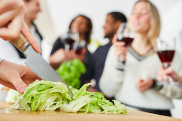 Salat mit Messer schneiden für Essen mit Freunden in WG