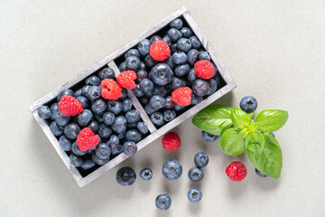 blueberries and raspberries in wooden crates.