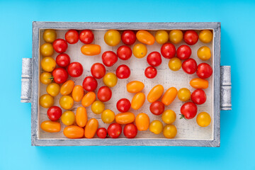 Top view of cherry tomatoes in small wooden crate