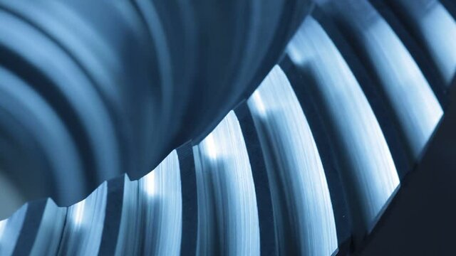 Close-up of a rotating gear wheel in an engine – blue color