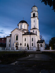 Religious building, Orthodox church dedicated to the Protection of the Holy Virgin with ominous, dark storm clouds in the background. Brod, Bosnia and Herzegovina.