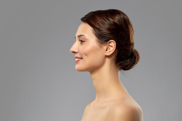 beauty, bodycare and people concept - profile of beautiful young woman with bare shoulders over...