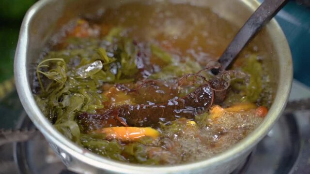 ginger, lemongrass, lime leaf and shaved wood shavings boiled in a pan, the raw material of jamu empon-empon
