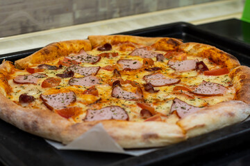 pizza with home delivery, eat at the table against the background of food