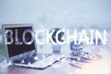 Multi exposure of blockchain and crypto economy theme hologram and table with computer background....