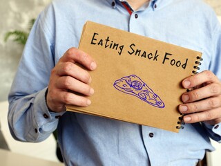 Motivation concept meaning Eating Snack Food with sign on the page.