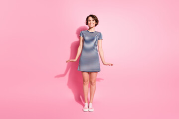 Full length photo of pretty nice lady skinny shapes good cheerful flirty mood wear casual white blue striped mini summer dress isolated pastel pink color background