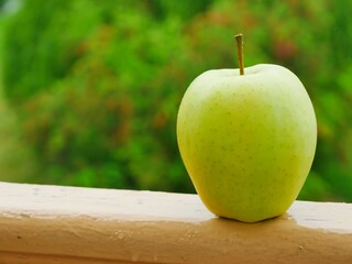 green apple on wooden table