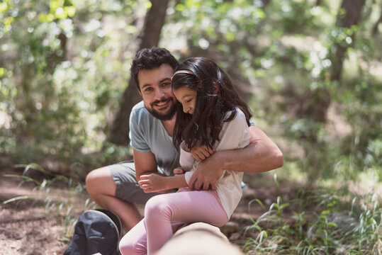 Father and daughter in the forest playing