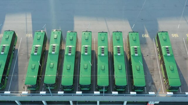 Birds Eye Aerial View of Green Electric Bus Parking in Stavanger, Norway. Aligned Vehicles, Modern Public Transportation