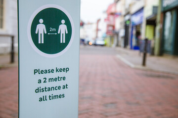 Please keep a 2 metre distance at all times sign. On the high street, as shops prepare to reopen on the 15th June following the Coronavirus Pandemic