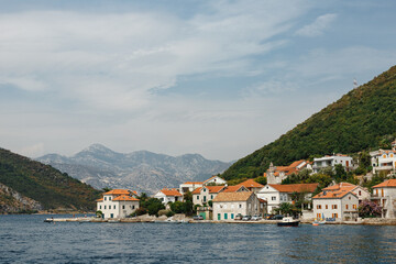 Fototapeta na wymiar The coastline of the city of Lepetane in Montenegro, near the ferry crossing through Kotor Bay.
