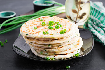 Traditional indian bread. Pita bread with green onions. Onion naan.