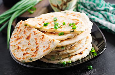 Traditional indian bread. Pita bread with green onions. Onion naan.