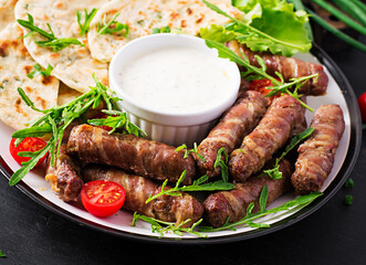 Pork kebab with pita bread with green onions.