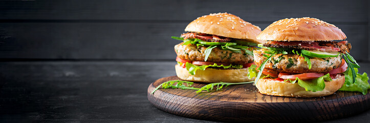Big sandwich - hamburger burger with turkey meat,  tomato,  bacon and lettuce. Banner - obrazy, fototapety, plakaty