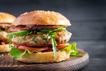 Big sandwich - hamburger burger with turkey meat,  tomato,  bacon and lettuce.