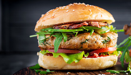 Big sandwich - hamburger burger with turkey meat,  tomato,  bacon and lettuce.