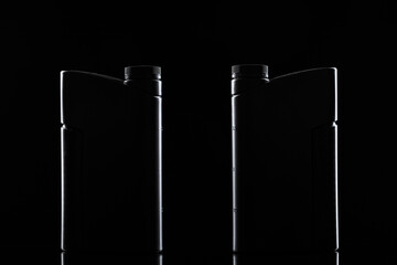 Engine oil bottle on black background, close up.