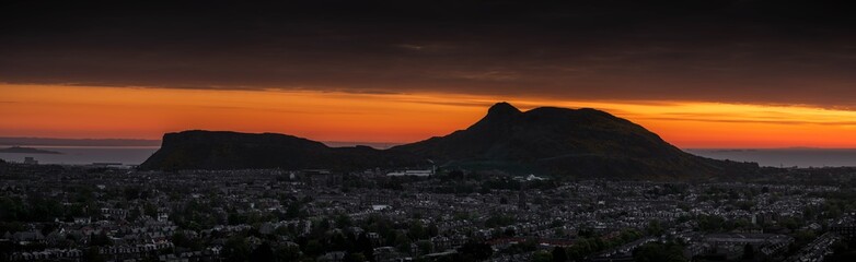 Dramatic panorama scene of sunrise sunset over the mountains - Arthur's Seat, Edinburgh