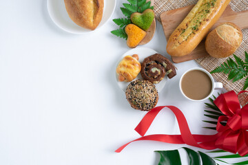 Top view of fresh bread and coffee,Fern leaf,monstera leaf, separate on a white background wood