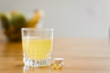 Close up glass with water and sparkling pill. Magnesium anti-stress, painkiller or orange drink