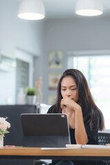 Concentrated young businesswoman working on her computer.