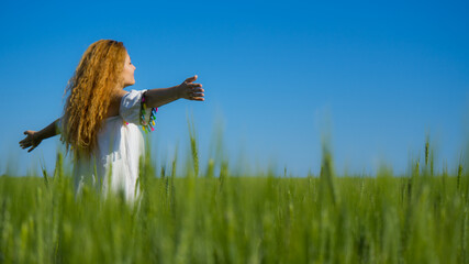 Summer holidays vacation of carefree beautiful long haired woman runs on summer sunny field. Positive happy girl in dress walks on sunny yard.Freedom or happiness summer sale concept.Social distance