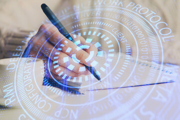 Double exposure of writing hands on background with data solution hologram on front. Technology concept. Close up