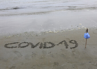 Text Covid-19 on the beach during the lockdown and the surgical