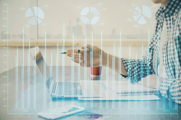 Multi exposure of stock market chart with man working on computer on background. Concept of financial analysis.