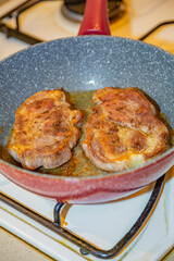 Juicy appetizing steaks  from fat pork fried in a pan with olive oil