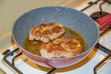 Juicy appetizing steaks  from fat pork fried in a pan with olive oil