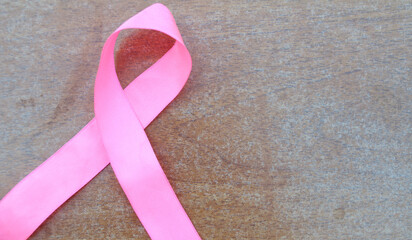 Pink awareness ribbon. Breast Cancer Ribbon. Hand with pink awareness ribbon. Support for women who...