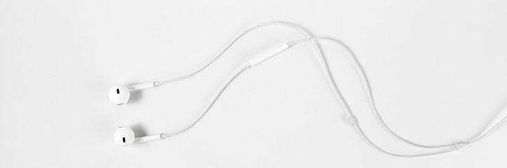 white earphone for listening isolated on gray background