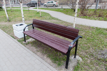 The bench stands by the path in the park