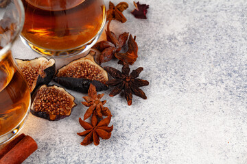 Cup of tea decorated with pieces of dried orange and fig