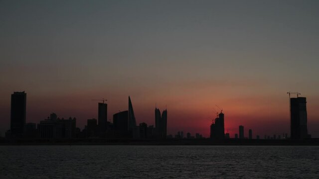 Timelapse of dusk to night with the crescent moon setting of the Diplomatic Area in Manama, Bahrain