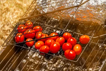 Fotobehang Red sherry tomatoes are grilled on the grill in nature. Picnic in the nature. © Vladimir