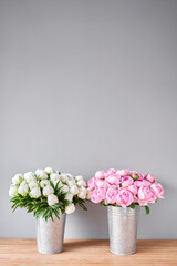 Different varieties of peonies in a metal vases. Beautiful peony flower for catalog or online store. Floral shop concept . Beautiful fresh cut bouquet. Flowers delivery