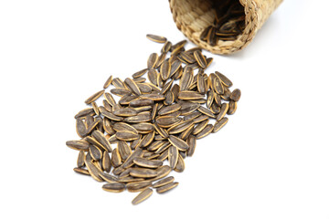 Pile of Sunflower Seed on Wooden Basket. Isolated White Background.