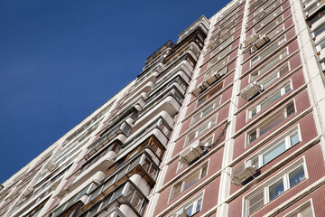 Fototapeta premium Residential building in the style of architecture of the USSR, facade and windows of a residential building
