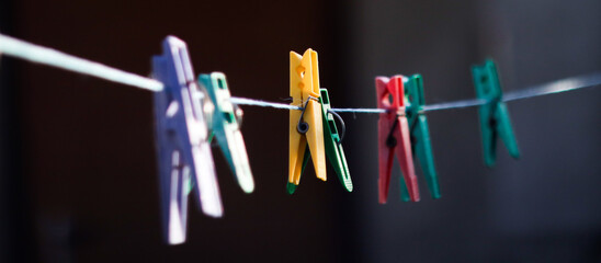 colorful clothespins hanging on a clothesline