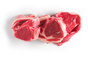 Three fresh raw lamb loin chops on a white background, isolated. Meat industry.