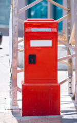 red mailbox on a city street