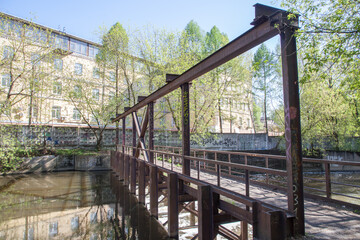 The dam in the middle of the river, factory buildings of the old factory