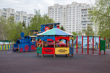 Playground in the courtyard of a residential building, children's steam locomotive, closed for quarantine