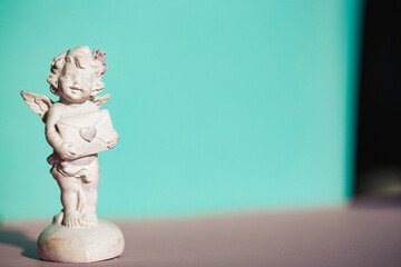 Figurines angels. Decorative angel on a background. Clay Figurines of angels in various poses....