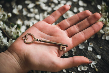 Hand with antique skeleton key. The key in a human hand.