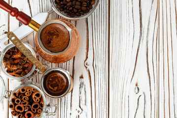 Coffee in metal turk with spices in a plate
